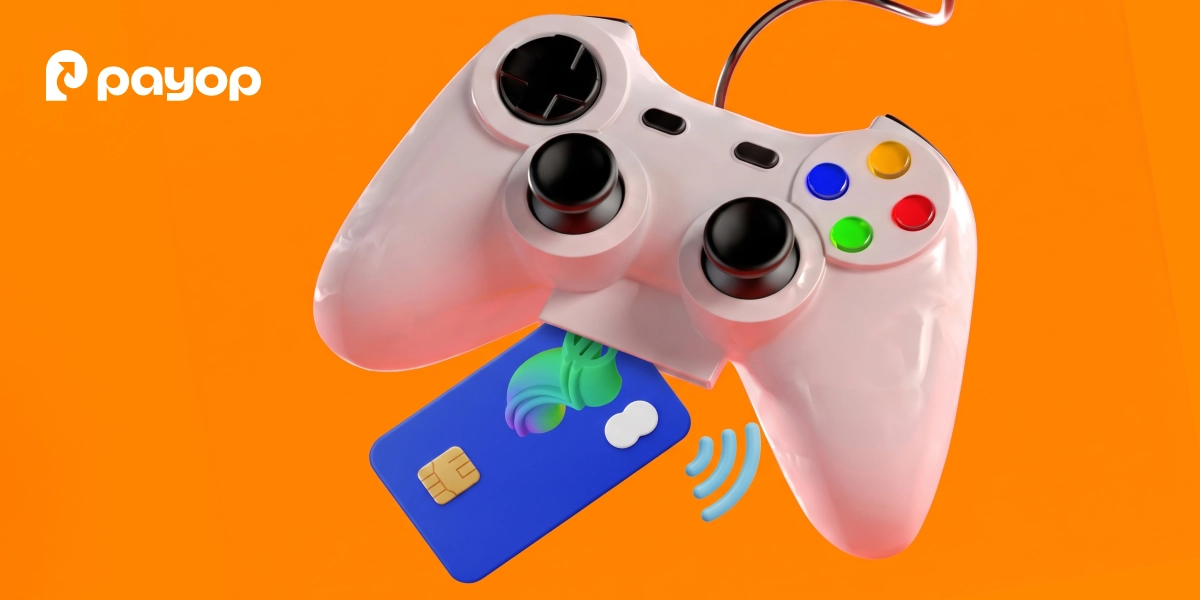 White gaming controller with a blue credit card on an orange background with Payop logo.